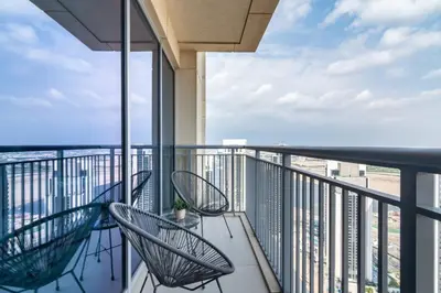 a balcony with two chairs and a view of the ocean at GuestReady - Sophistication Skyview Harbour in Dubai