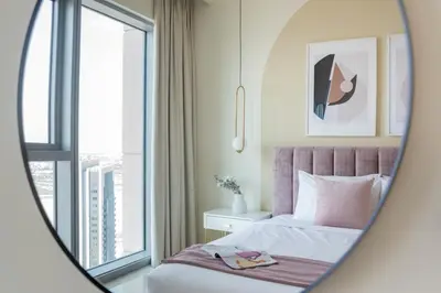 a hotel room with a bed and a window at GuestReady - Sophistication Skyview Harbour in Dubai