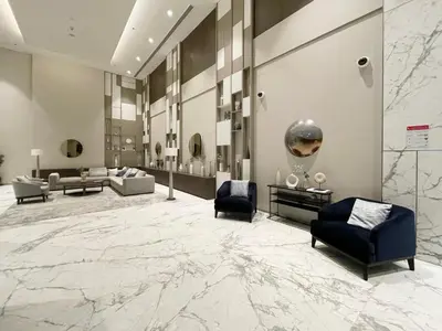 a lobby with couches and chairs and a large marble floor at GuestReady - Sophistication Skyview Harbour in Dubai