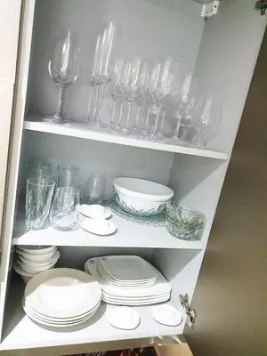 a shelf filled with glasses and plates and dishes at Luxurious Escape meets Fendi Design in Iconic Building on Top Location in Dubai Marina in Dubai