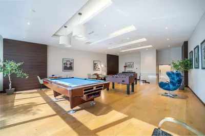 a billiard room with a pool table and two tables at Luxurious Escape meets Fendi Design in Iconic Building on Top Location in Dubai Marina in Dubai