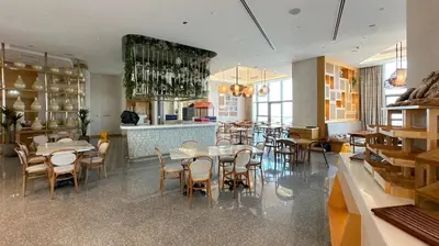 a dining room with tables and chairs in a restaurant at High Floor 2 Bedroom Gem - Burj Khalifa Views in Dubai