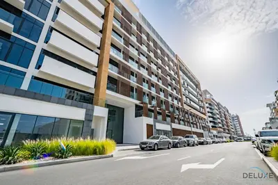 a row of cars parked in front of a building at Beautiful Studio at Azizi Riviera 17, Al Merkadh by Deluxe Holiday Homes in Dubai