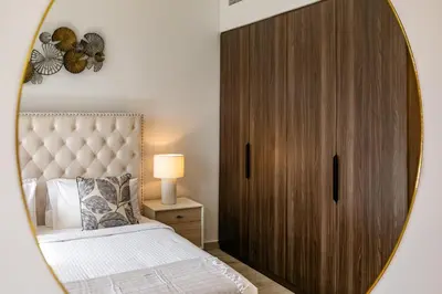 a bedroom with a large mirror next to a bed at Apartment 1BDR in Madinat Jumeirah I Asayel 3 in Dubai