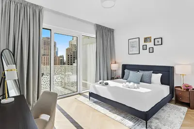 a bedroom with a large bed and a large window at Elegant and Modern 1BR Apt in JBR with Beach Access in Dubai