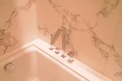 a bathroom with a bath tub with a sink at THE CLOSEST building to Burj Khalifa with Fountain View in Address Opera Residence in Dubai