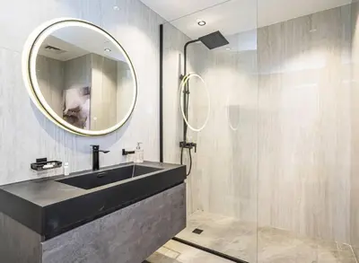 a bathroom with a black sink and a mirror at New Arabian Shams 2 JBR Sea View in Dubai