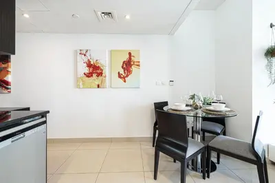 a kitchen and dining room with a table and chairs at Whispers of the Wind by Lagom Vacation Homes in Dubai
