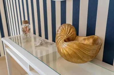 a gold heart shaped bowl sitting on a glass table at 7 Beds / JBR / Sea, JBR Beach and Ain Dubai Views / 3 min walk from JBR Beach / Large Groups and Families / Ideal Vacation Location in Dubai