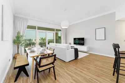 a living room with a white couch and a table at Luxury Living w private beach and Burj AlArab view in Dubai
