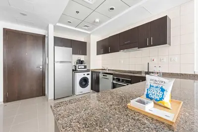 a kitchen with stainless steel appliances and a counter top at Silkhaus in Dubai Marina Heart, Opposite to Marina Mall in Dubai