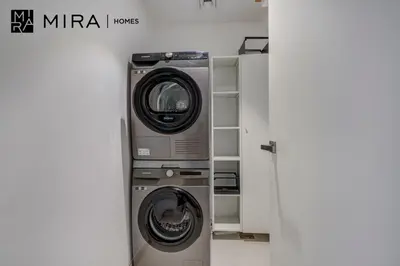a washing machine and a dryer in a room at Mira Holiday Homes - Newly 1 bedroom with sea view in Dubai