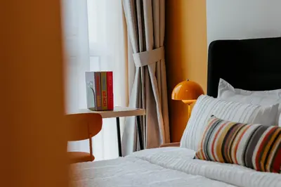 a bedroom with a bed and a book on a window at Coolest 1 BR in Dubai Hills close to the Park in Dubai