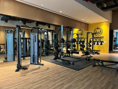 a gym with a lot of treadmills and weights at Beachside Bliss: Stylish New Studio at Seven Palm in Dubai