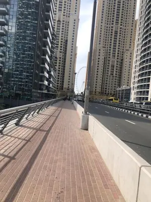 a bridge in a city with tall buildings at Stay in heart of Dubai Marina, walk to JBR! #3 in Dubai