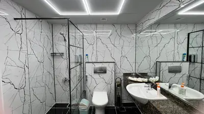 a bathroom with two sinks and a shower and a toilet at Stay in heart of Dubai Marina, walk to JBR! #3 in Dubai