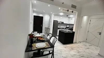 a kitchen and dining room with a table and chairs at Stay in heart of Dubai Marina, walk to JBR! #3 in Dubai