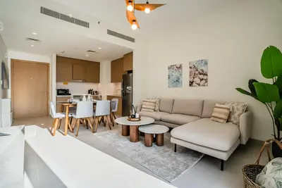 a living room with a couch and a table at Coastal Vibe I 1BDR apartment in Creek Beach I Summer 2 in Dubai