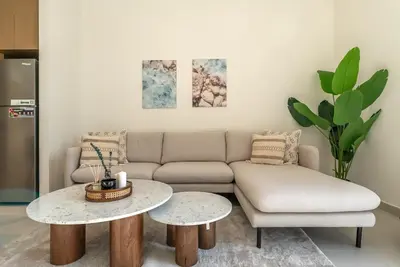 a living room with a couch and a table at Coastal Vibe I 1BDR apartment in Creek Beach I Summer 2 in Dubai