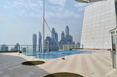 a swimming pool on top of a building with a city skyline at GuestReady Holiday Homes - Lux Studio with a View in Dubai