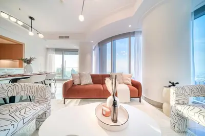 a living room with a couch and chairs at Downtown Luxury - Stunning Burj Khalifa & Sea View - 5 Minutes Walk to Dubai Mall in Dubai