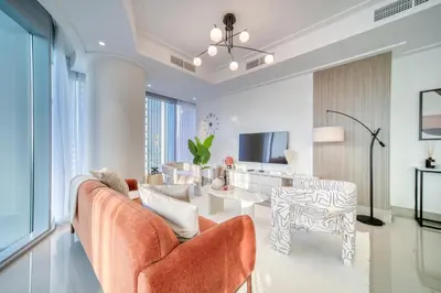 a living room with a couch and a table at Downtown Luxury - Stunning Burj Khalifa & Sea View - 5 Minutes Walk to Dubai Mall in Dubai