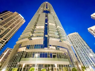 a tall building with a blue sky in the background at Downtown Luxury - Stunning Burj Khalifa & Sea View - 5 Minutes Walk to Dubai Mall in Dubai