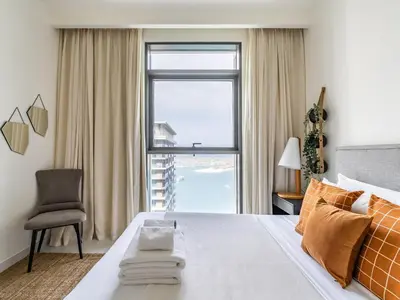 a bedroom with a bed and a large window at Sea-Front Unique Retreat With Balcony in Marina in Dubai