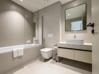 a bathroom with a sink toilet and a mirror at Sea-Front Unique Retreat With Balcony in Marina in Dubai