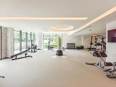 a gym with treadmills and cardio equipment in a room at Sea-Front Unique Retreat With Balcony in Marina in Dubai