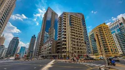 a city with tall skyscrapers on a city street at SettlerHomes - Sparkle Tower 2 With Marina & Sea View in Dubai
