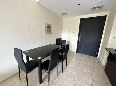 a dining room with a black table and black chairs at Diomond view 4 in Dubai