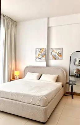 a bedroom with a large bed with white sheets at Stylish & Roomy 1BR in the Heart of the City in Dubai