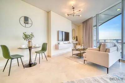 a living room with a couch and a table and chairs at Grand Studio at Sky Gardens DIFC by Deluxe Holiday Homes in Dubai