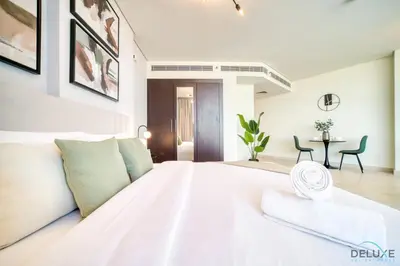 a large white bedroom with a large white bed at Grand Studio at Sky Gardens DIFC by Deluxe Holiday Homes in Dubai