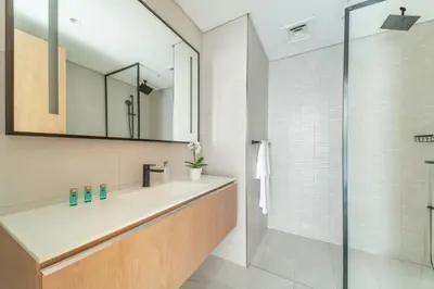 a bathroom with a sink and a shower at Frank Porter - Marquise Square Tower in Dubai