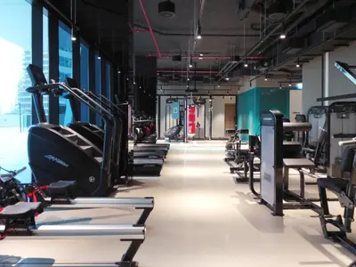 a gym with rows of treadms and cardio machines at Frank Porter - Marquise Square Tower in Dubai