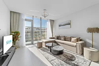 a living room with a couch and a table at ALiving Classy 2BR I Lagoons View I District One Residence 7 in Dubai