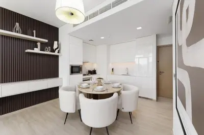 a dining room with a table and white chairs at Luxe 1-Bedroom Elegance in Palace Residences in Dubai