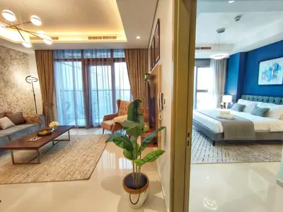 a living room with a bed and a couch at White Sage - Deluxe Apartment With Unobstructed Sea Views in Dubai