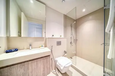 a bathroom with a sink and a toilet and a shower at Downtown - 2BR Apartment with Burj Khalifa View in Dubai