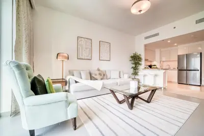 a living room with a couch and a table at Downtown - 2BR Apartment with Burj Khalifa View in Dubai