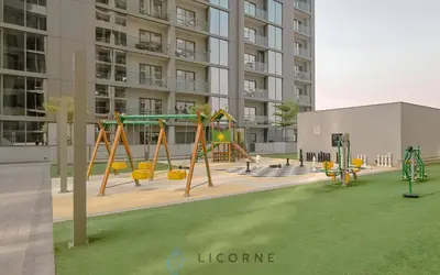 an empty playground in front of a building at Inviting 2BR Apartment - Only 10 Mins to Downtown - Sobha Creek Vista Reserve in Dubai