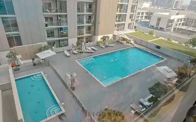 an overhead view of a swimming pool in a building at Inviting 2BR Apartment - Only 10 Mins to Downtown - Sobha Creek Vista Reserve in Dubai