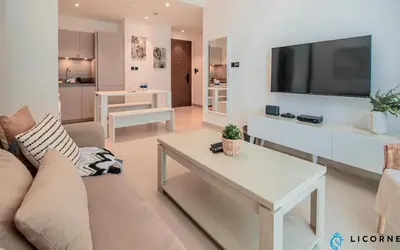 a living room with a couch and a tv at Inviting 2BR Apartment - Only 10 Mins to Downtown - Sobha Creek Vista Reserve in Dubai