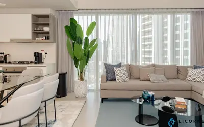 a living room with a couch and a table at Brand New Modern 2BR Retreat, Walk to Dubai Mall - Downtown Views ll in Dubai