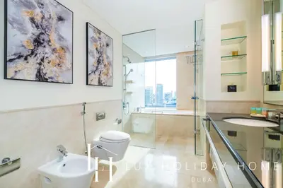 a bathroom with a toilet and a sink and a shower at LUX The JW Marina Studio in Dubai