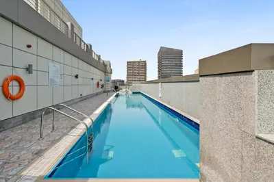 a swimming pool on the side of a building at Modern Sports City Studio Pool, Gym & Stadium in Dubai