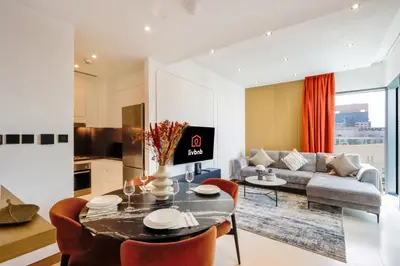 a living room with a table and a couch at 1BR Gem with Stunning Marina Views, Close to Metro in Dubai