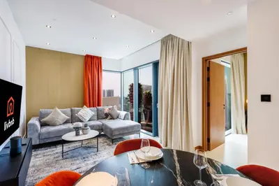 a living room with a couch and a table at 1BR Gem with Stunning Marina Views, Close to Metro in Dubai